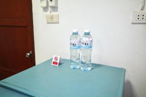 two bottles of water sitting on a blue table at Chanathinat Place in Udon Thani