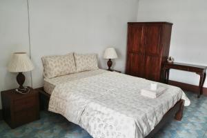 a bedroom with a bed and a chair and a dresser at Chanathinat Place in Udon Thani +12 photos