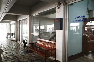 a bench sitting in front of a store window at Chanathinat Place in Udon Thani