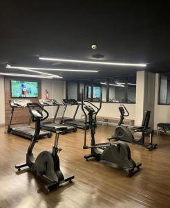 a gym with several tread machines in a room at Flat Aconchegante Hotel Intercity Manaus in Manaus