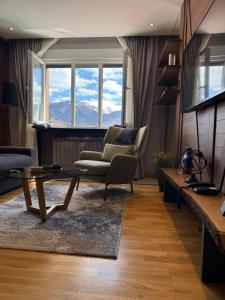 a living room with a coffee table and a chair at Lavina MM2 in Kolašin