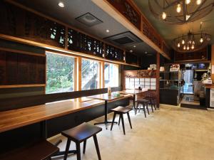 a restaurant with tables and chairs in a room at 虎屋旅館 in Kotohira +16 photos