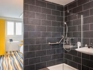 a bathroom with a shower and a sink at ibis Styles Meaux Centre in Meaux +50 photos