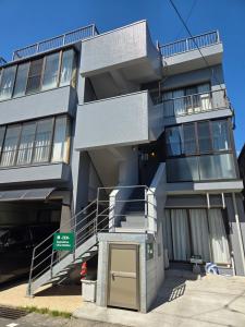 a tall building with a stairway in front of it at 禅 Zen 鹿児島 フロア貸切 中央駅徒歩14分 in Yamashitachō