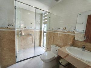a bathroom with a shower and a toilet and a sink at Coast Pearl Hotel in Phú Quốc +29 photos