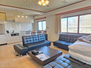 a living room with a couch and a table at 禅 Zen 鹿児島 フロア貸切 中央駅徒歩14分 in Yamashitachō