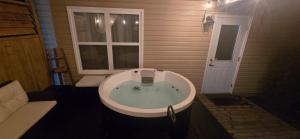 a bath tub in a room with a window at Cozy Basement Suite in Lower Sackville +7 photos