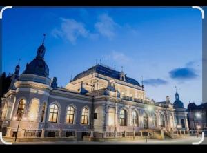 a large building is lit up at night at Apartament City Center Dorna in Vatra Dornei