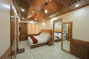 a bedroom with two beds and a mirror at Supreme Sapphire Kufri in Fagu