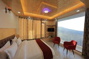 a bedroom with a bed and a large window at Supreme Sapphire Kufri in Fagu
