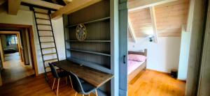 a small room with a desk and a bed at Chalupa Louka in Slavonice