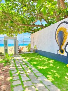 a wall with a painting of a peacock on it at Wallama Villa in Ambalangoda