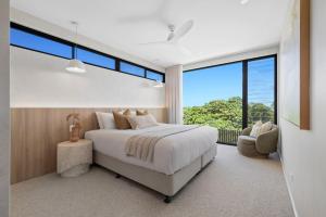 a bedroom with a large bed and a large window at Solis Villa in Pottsville +47 photos