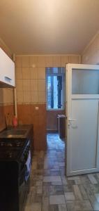 a kitchen with a white refrigerator and a stove at Apartament City Center Dorna in Vatra Dornei