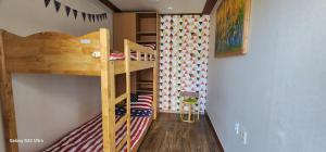 a room with two bunk beds and a wall with flags at Jarasum guesthouse in Kap'yŏng-yŏk