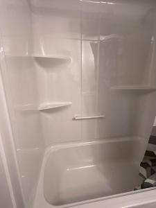a white refrigerator with empty shelves in it at Moonlight Suite in Riverview