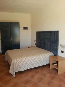 Un pat sau paturi într-o cameră la La Casetta di Sara