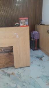 a wooden counter with a box on top of it at Hotel Prabhawati Palace Near Railway Station and Sri Vishwanath Temple Varanasi in Varanasi