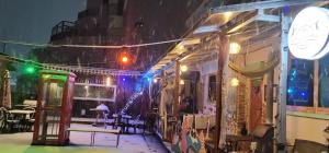 a building with snow falling on the side of it at Jarasum guesthouse in Kap'yŏng-yŏk +10 photos