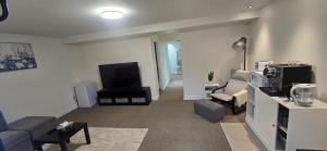 a living room with a flat screen tv and a couch at Cozy Basement Suite in Lower Sackville