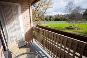 a porch with two chairs and a table and a window at Edinburgh Motor Inn in Warragul