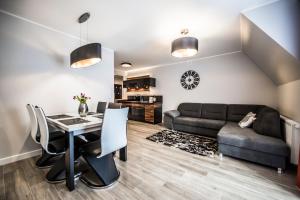 a living room with a table and a couch at Apartamenty Gubałówka in Zakopane