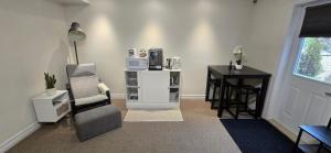 a room with a desk and a chair and a table at Cozy Basement Suite in Lower Sackville