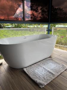 a white bath tub sitting in front of a window at Suite Palm in Palma +19 photos