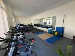a gym with several treadmills and exercise bikes at Studio condo oceanside - pools, gym, mini market in Dao