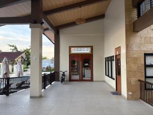 a front door of a building with a sign on it at Studio condo oceanside - pools, gym, mini market in Dao
