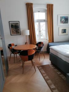 a bedroom with a bed and a table and chairs at Villa Taxus-Smokers not welcome in Dresden