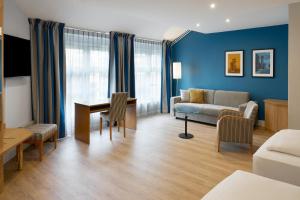 a living room with a couch and a table at Four Points Flex by Sheraton Kiel in Kiel