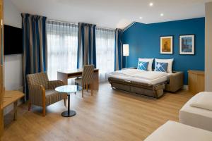 a hotel room with a bed and a table at Four Points Flex by Sheraton Kiel in Kiel