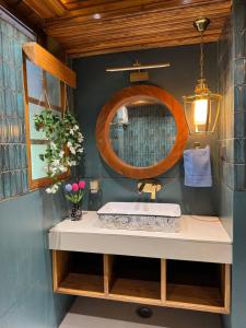 a bathroom with a sink and a mirror at Arcelia Cottage, Cozy Villa in Nainital in Nainital
