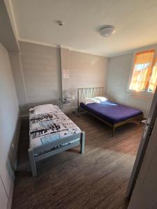 a bedroom with two beds and a window at Le Bel Air - Decize in Decize