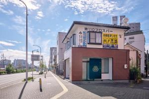 a building on the side of a city street at R STAY Nagoya Atsuta in Nagoya