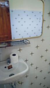 a bathroom with a sink and a mirror with stars on the wall at KOHRONG khmerhome in Kaôh Rŭng (3)