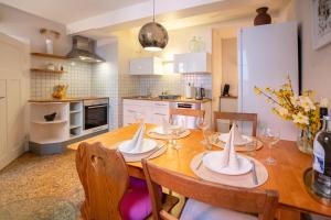 a kitchen with a wooden table with chairs and a dining room at Schwarzwald Ferienhäuser in Haslach im Kinzigtal