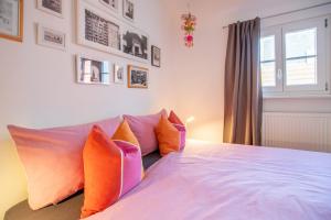 a bedroom with a large bed with colorful pillows at Schwarzwald Ferienhäuser in Haslach im Kinzigtal