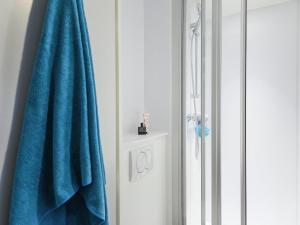 a bathroom with a blue towel next to a shower at hotelF1 Toulouse L'Union in LʼUnion +66 photos