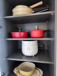 a kitchen with pots and pans sitting on shelves at 히얼마리나 in Ungch'ŏn-ni +17 photos