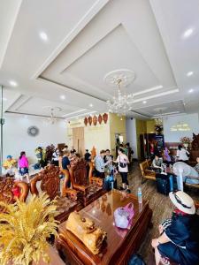 a group of people sitting in a lobby at Hotel Luxstay in Pleiku