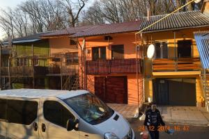 a van parked in front of a house at Cottage 5 in Karpaty