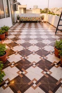 a balcony with a tiled floor with a couch at Absolute hostel in Meerut