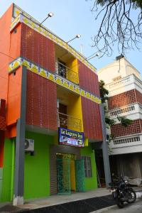 a colorful building with a motorcycle parked in front of it at Le Lagrave Inn in Pondicherry