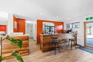 a kitchen with a bar and stools in a restaurant at Anchor Wheel Motel in St Helens