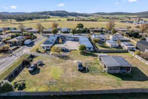 an aerial view of a farm with cars parked in a field at Anchor Wheel Motel in St Helens