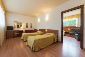 Postel nebo postele na pokoji v ubytování Hotel Doge