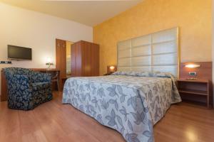 Postel nebo postele na pokoji v ubytování Hotel Doge