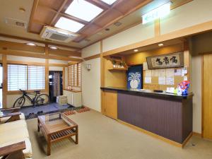 a living room with a bar in the middle at おばな旅館 富貴亭 in Nagano